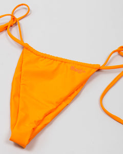 close up of orange bikini bottom with saga logo